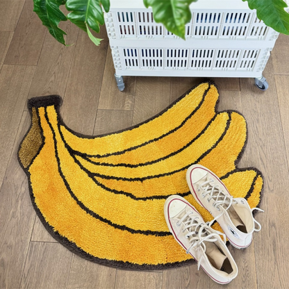 Bunch of Bananas rug in yellow, shaped like a bunch, with a pair of trainers on top.
