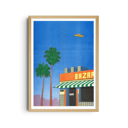 Framed poster of palm trees, an orange shop and a UFO in a blue sky