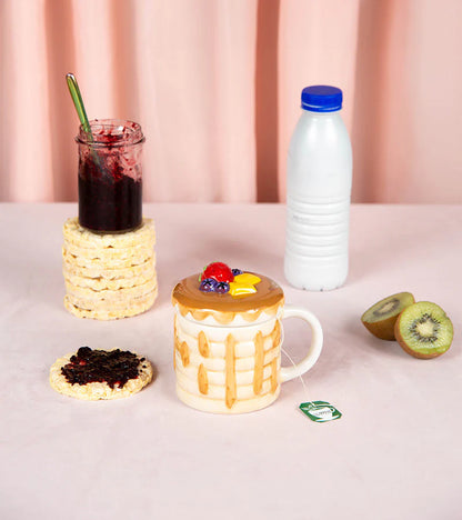 Pancake mug with a lid shaped like a pancake topped with berries and mango