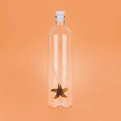 Atlantis Starfish bottle with a white stopper, on an orange background