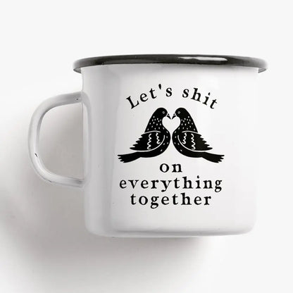 Tazza Let's Shit: a white mug with two stylised black birds and the words 'Let's shit on everything together'.