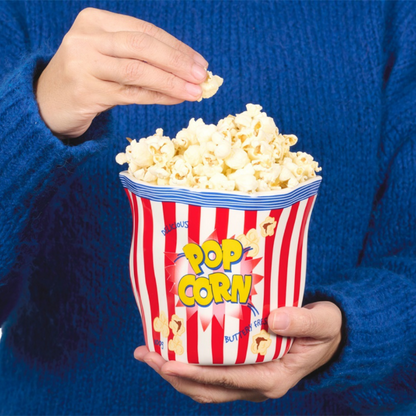 Pop Corn container vase full of popcorn, held by someone in a blue jumper.