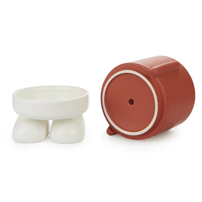 Mr. Standy flower vase disassembled, the white base and feet separated from the terracotta body