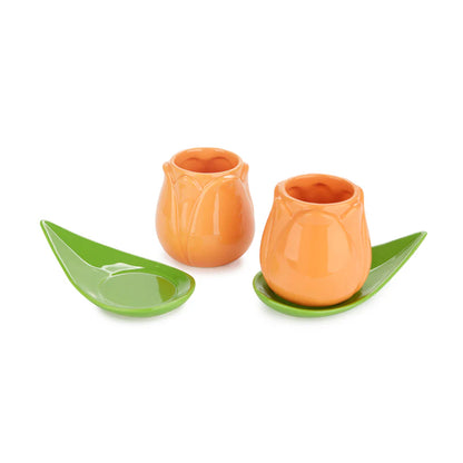 Tulip Coffee Cup Set: the two orange tulip-shaped cups on green leaf saucers, white background.