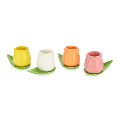 Four tulip-shaped cups in yellow, white, orange and pink, on green leaf saucers
