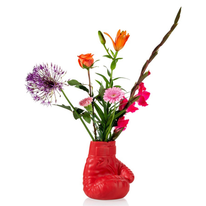 Boxing Glove vase in red filled with a bunch of colourful flowers.