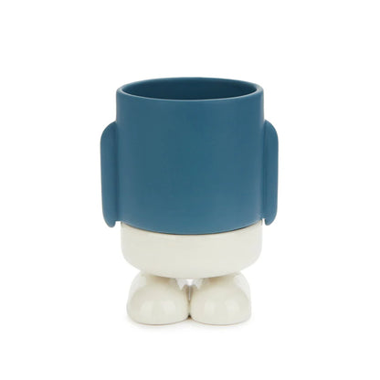 Blue robot-shaped planter with white legs and feet, empty, on a white background