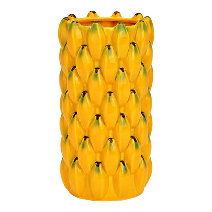 Yellow vase textured like stacked bananas, empty, on a white background