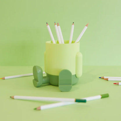 Mr.Sitty pen holder green pot with coloured pencils inside, on a light green background.