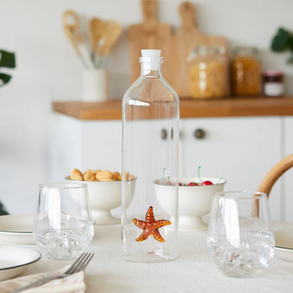 Atlantis Starfish bottle on a kitchen table with bowls of biscuits and cherries