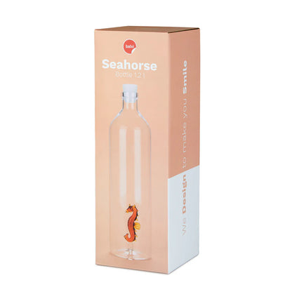 The seahorse bottle shown in its peach-coloured box
