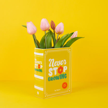Yellow Book vase with pink tulips, the yellow cover on a yellow background