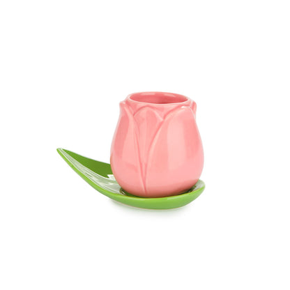 Pink Tulip cup on a green leaf saucer, on a white background