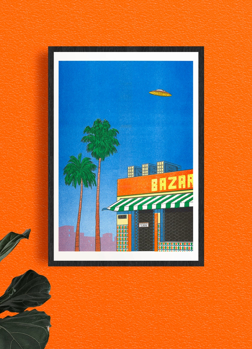 Spain At 15:00 poster framed on an orange wall, palm trees and a flying saucer over a building