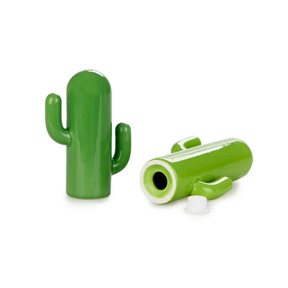 Sale & Pepe Cactus green ceramic shakers, one lying open to show the white stopper underneath.