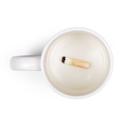 Cigarette Butt mug seen from a slight angle above, the fake butt resting on the white base.