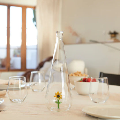 Botanical Sunflower 1L bottle on a set table with glasses and biscuits
