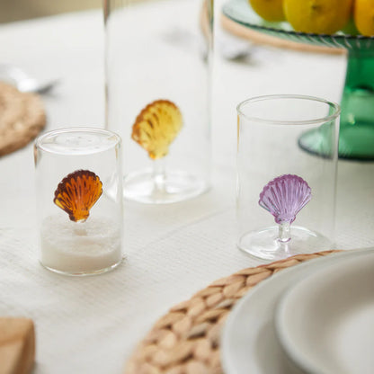 Atlantis Shell glass in three colours on a table set with fruit