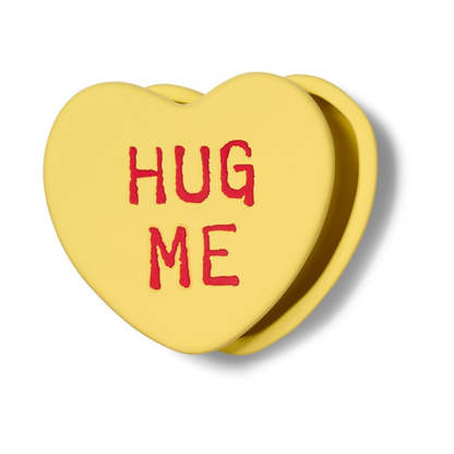 Hug Me heart-shaped box in yellow, seen at an angle with the lid slightly open.