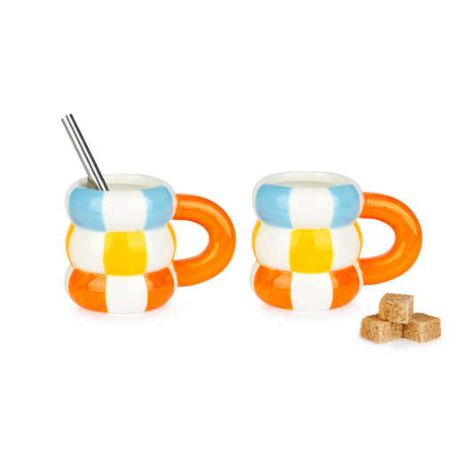 The small striped mugs with a metal spoon and sugar cubes