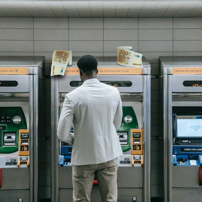 €200 toilet paper lifestyle scene with banknotes flying near a man at metro ticket machines.