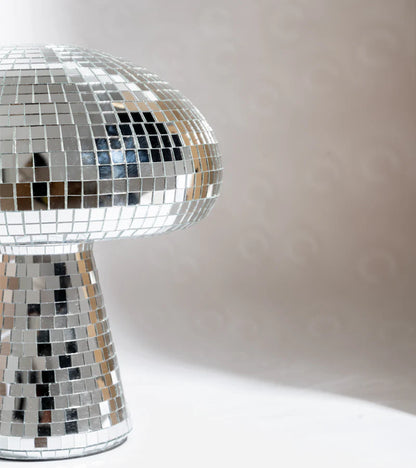 Disco mushroom lamp, close-up on the mirrored stem and cap