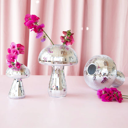 Small disco mushroom pot in three sizes with fuchsia flowers on a pink backdrop