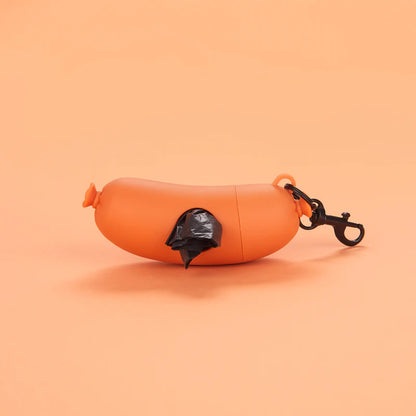 Dog waste bag holder shaped like a hot dog, photographed against an orange background.