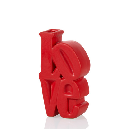 Love vase in red shaped like the letters LOVE, seen from a slightly different angle.