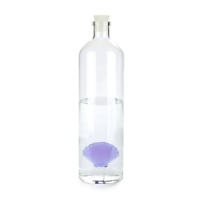 Atlantis Shell bottle filled with water, the white stopper placed beside it
