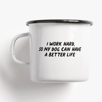 Tazza Vita da Cane: a white enamel mug printed with 'I WORK HARD, SO MY DOG CAN HAVE A BETTER LIFE'.