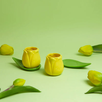 Tulip Coffee Cup Set: the yellow cups on green background surrounded by tulip flowers.