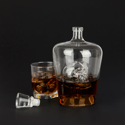 Poison Bottle: the decanter with the skull inside, filled with whisky, black background.