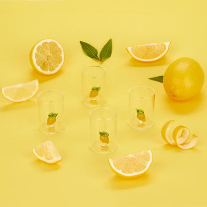 Lemon Shot Glass Set: the four empty glasses among lemons and mint leaves, yellow background.