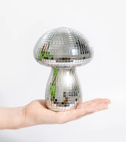 Mini disco mushroom lamp resting in the palm of a hand