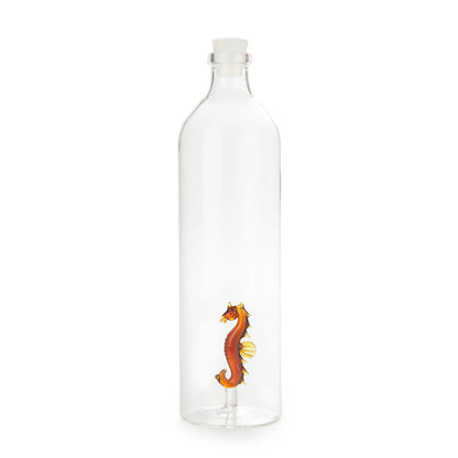 Clear glass bottle with an orange seahorse detail at the base