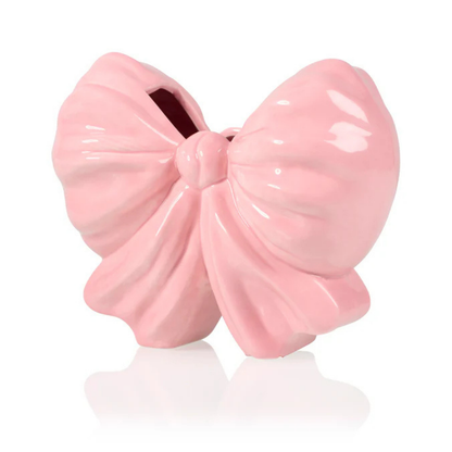 Fiocco bow-shaped vase in glossy pink, front view with no flowers, on white.