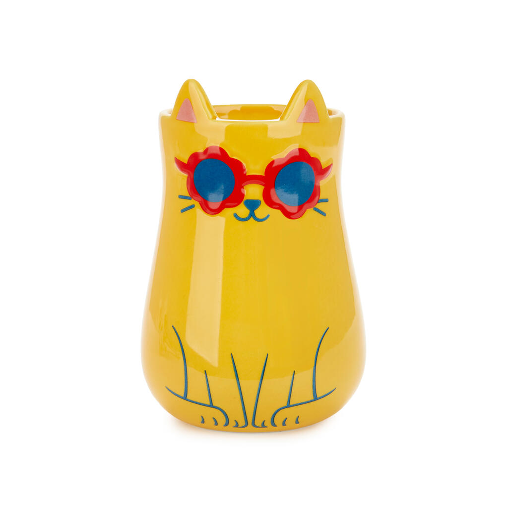 Yellow cat-shaped vase wearing red and blue sunglasses, on white