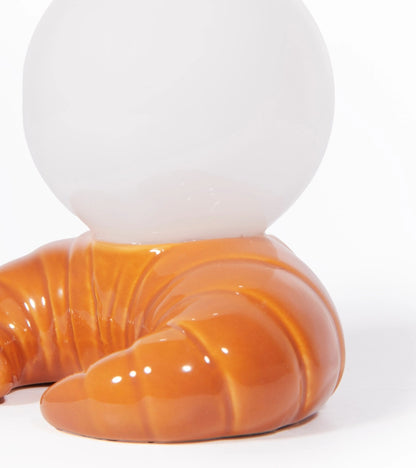 Croissant lamp, close-up on the croissant-shaped base and the sphere