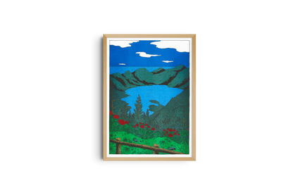 Framed poster of a mountain lake with red flowers in the foreground