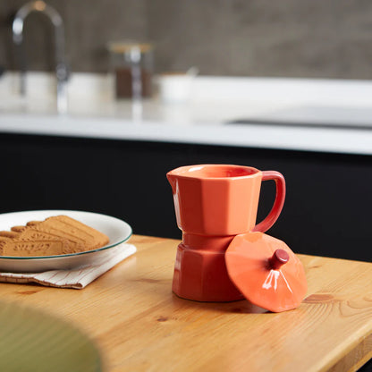 Orange Moka mug on a red background with brown sugar cubes