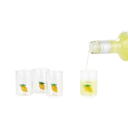 Lemon Shot Glass Set: the bottle pouring liqueur into one glass among the empty ones.