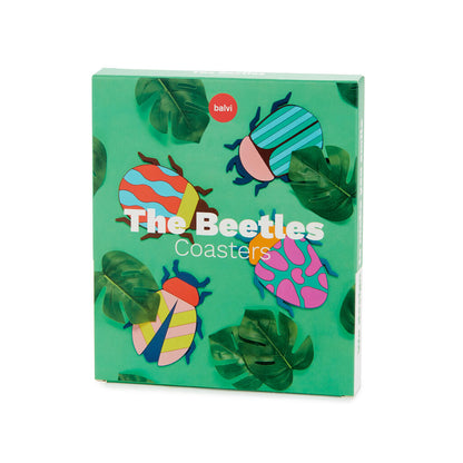 Beetle coasters in their box, printed with tropical leaves on the packaging.