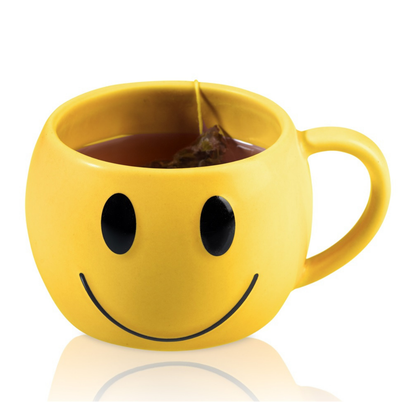 Mood mug, yellow smiley-face shaped cup with a tea bag inside