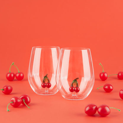 Botanical Cherry glass set surrounded by real cherries scattered on the table