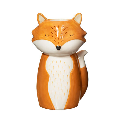 Finley Fox vase in orange and white shaped like a fox with closed eyes, tail forming the handle.