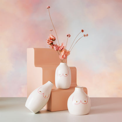 Girl Power Trio vases with dried flowers, styled on a terracotta-coloured plinth.