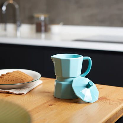 Mint green Moka mug on a green background with brown sugar cubes