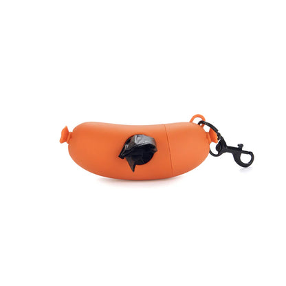 Dog waste bag holder shaped like an orange hot dog, with a black bag pulled out.