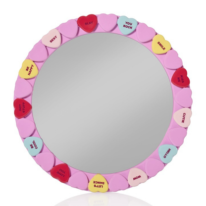 Candy Heart mirror: round mirror framed by pink candy hearts printed with little words.